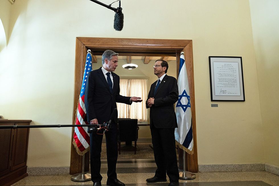 photo of two men speaking in front of microphones