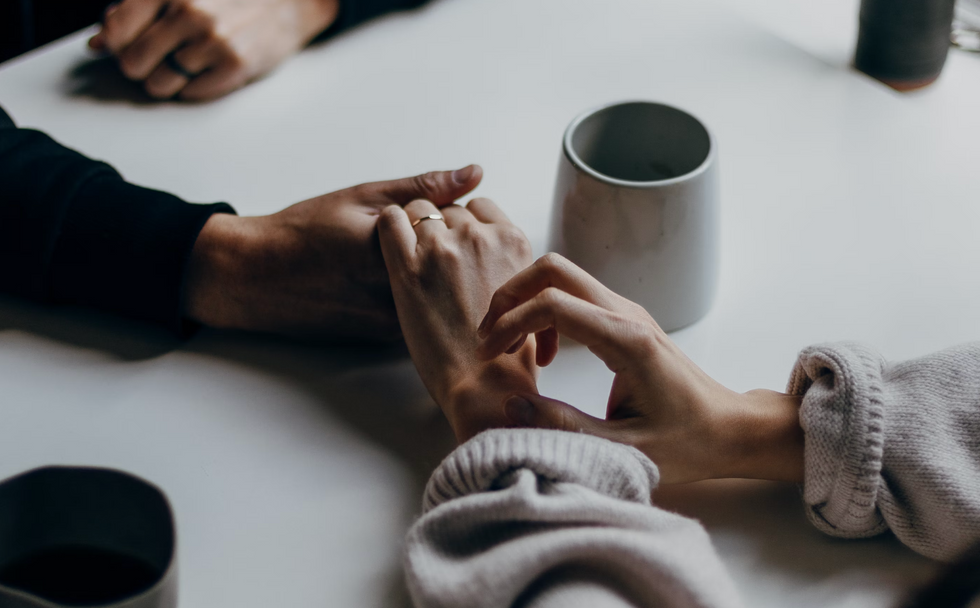 Photo of two people holding hands