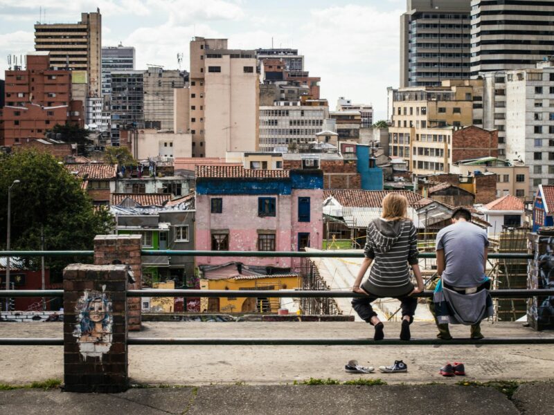 Photo of two people sitting in Colombia facing the city
