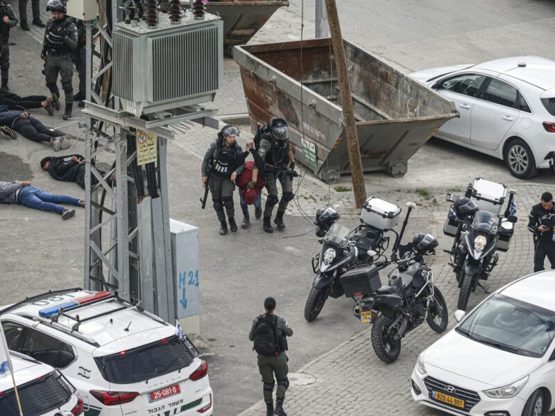 photo of two police arresting someone