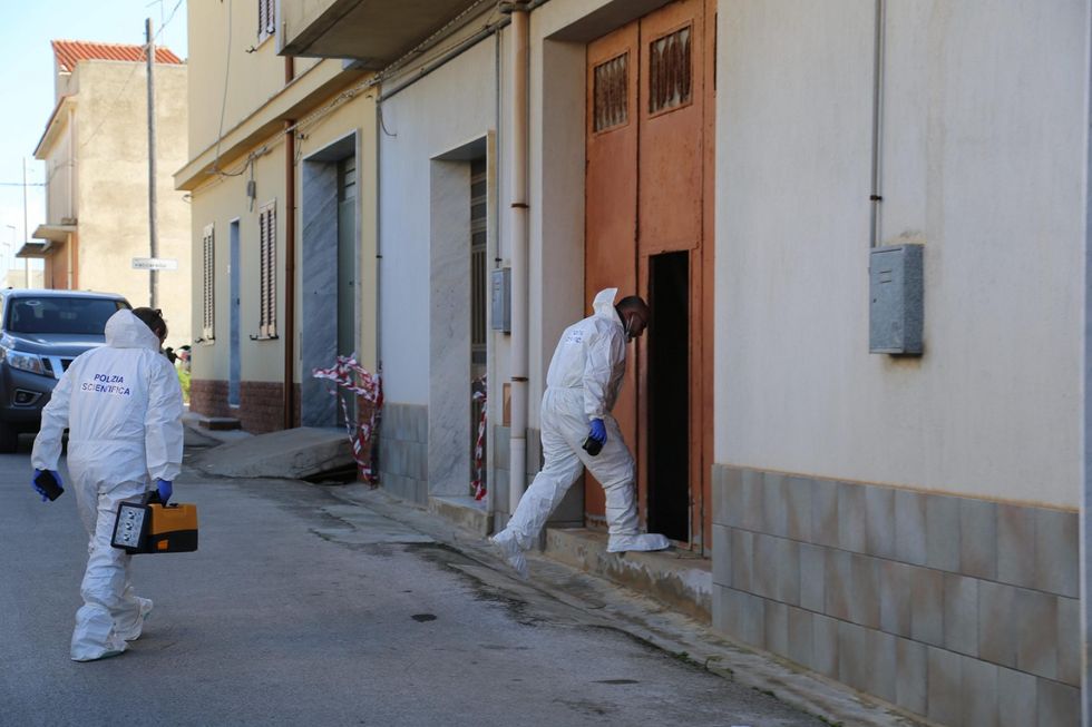 Photo of two policemen entering Messina Denaro's hideout