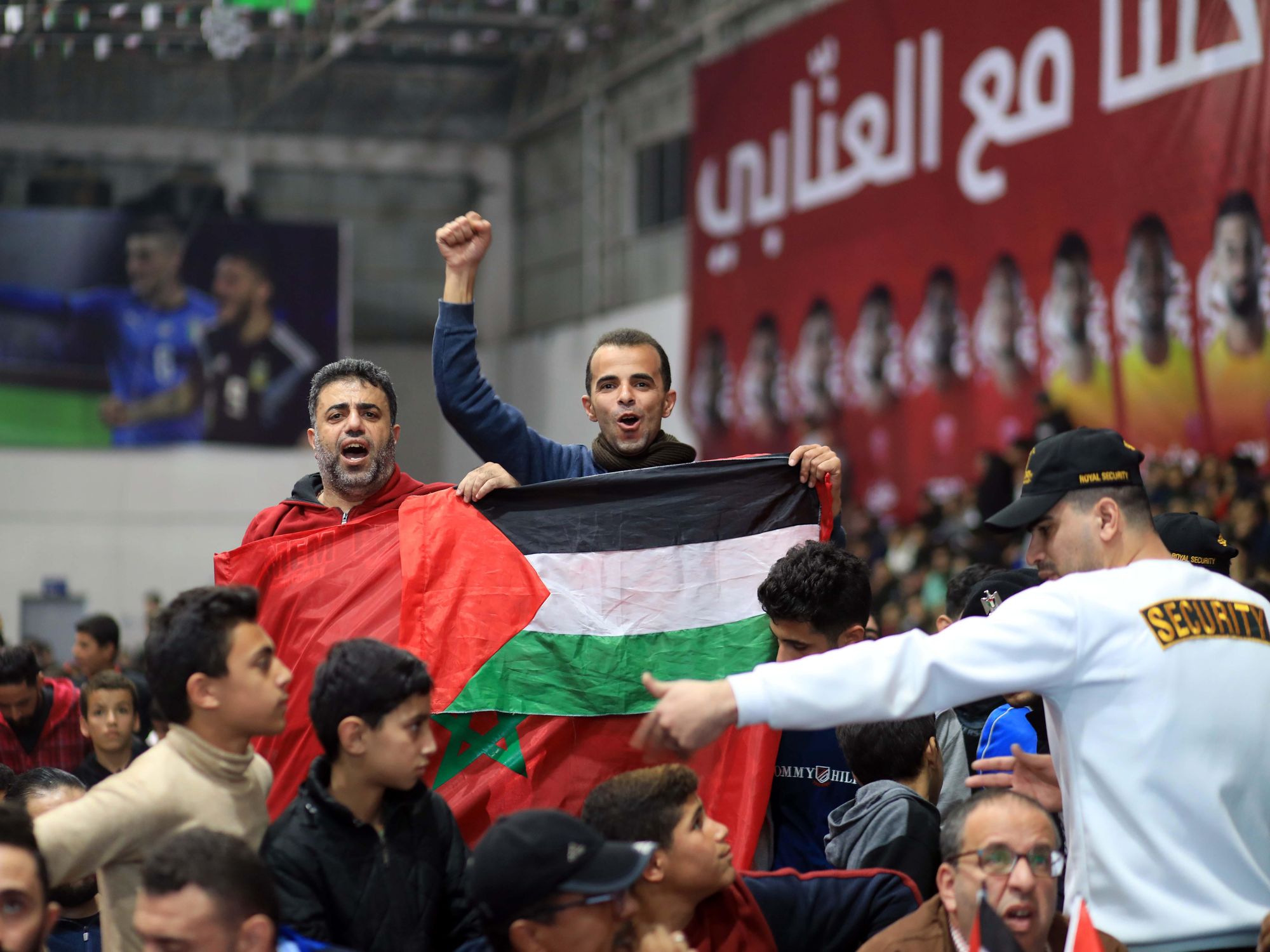 photo of two supporters of morocco with moroccan and palestinian flags in gaza