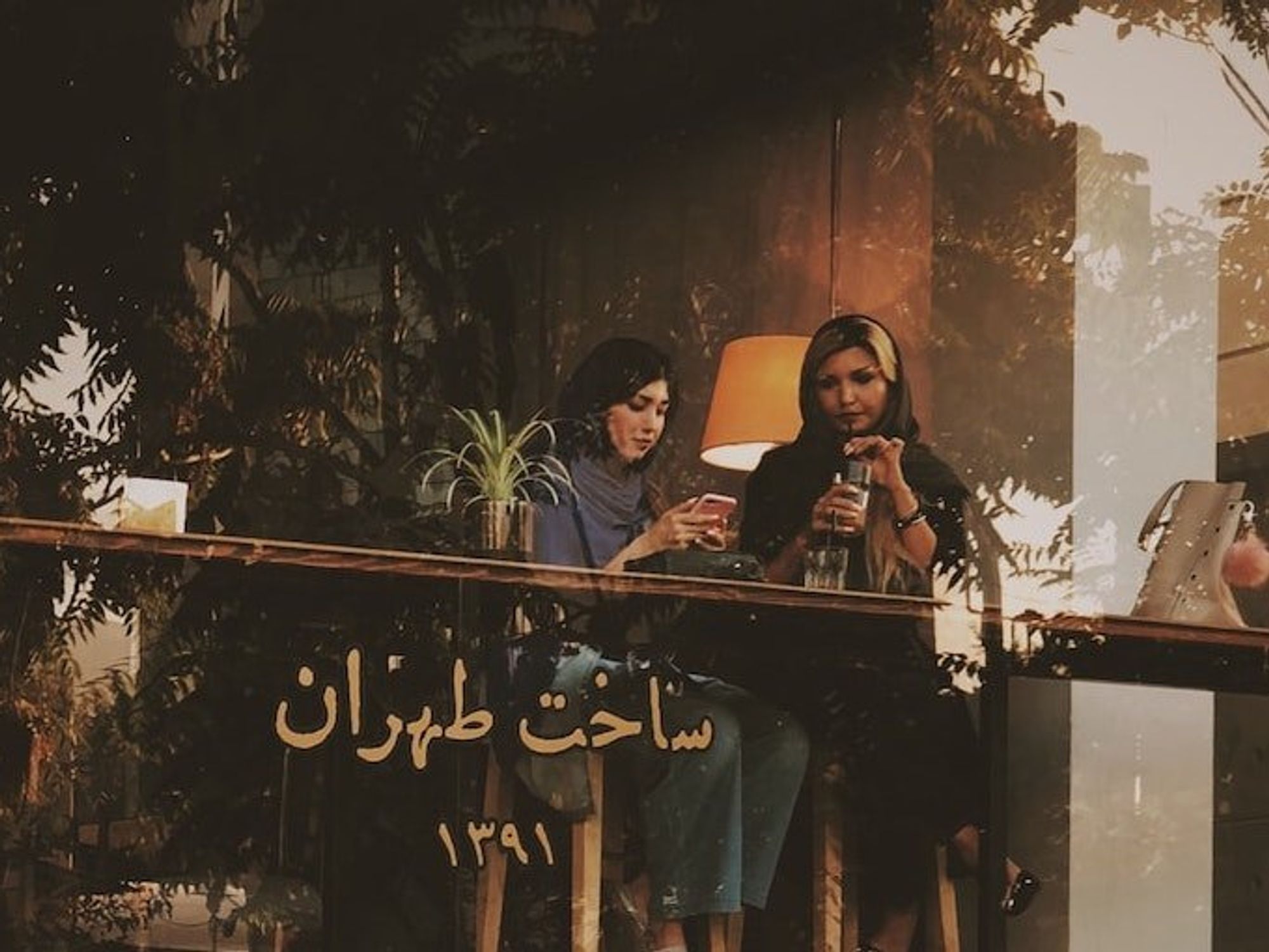 Photo of two women in a cafe in Tehran, Iran.