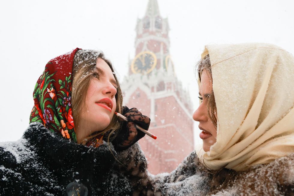 Photo of two women in front of the Kremlin's Spasskaya Tower.