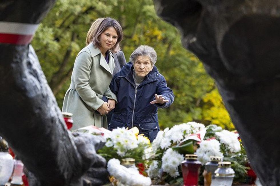 Photo of two women standing in a cemetery.