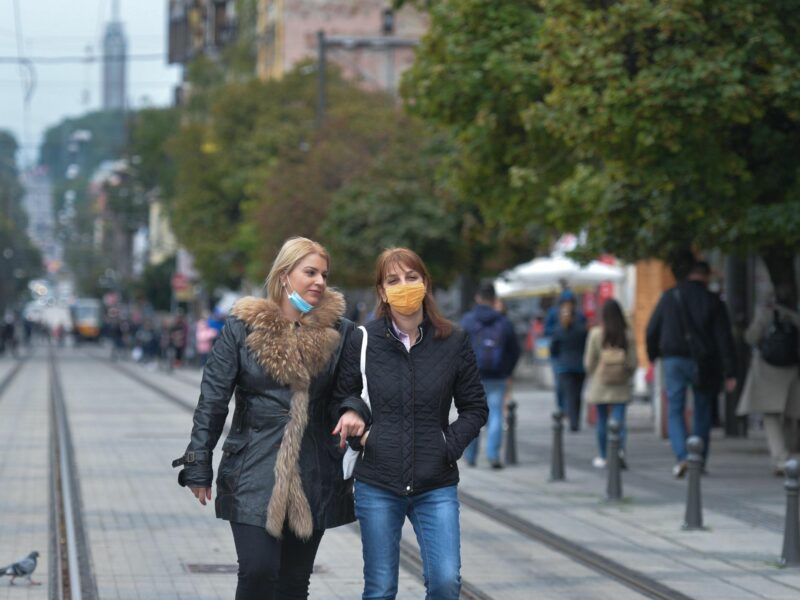 Photo of two women wearing COVID protective masks walking in the city center of Bulgaria's capital, Sofia