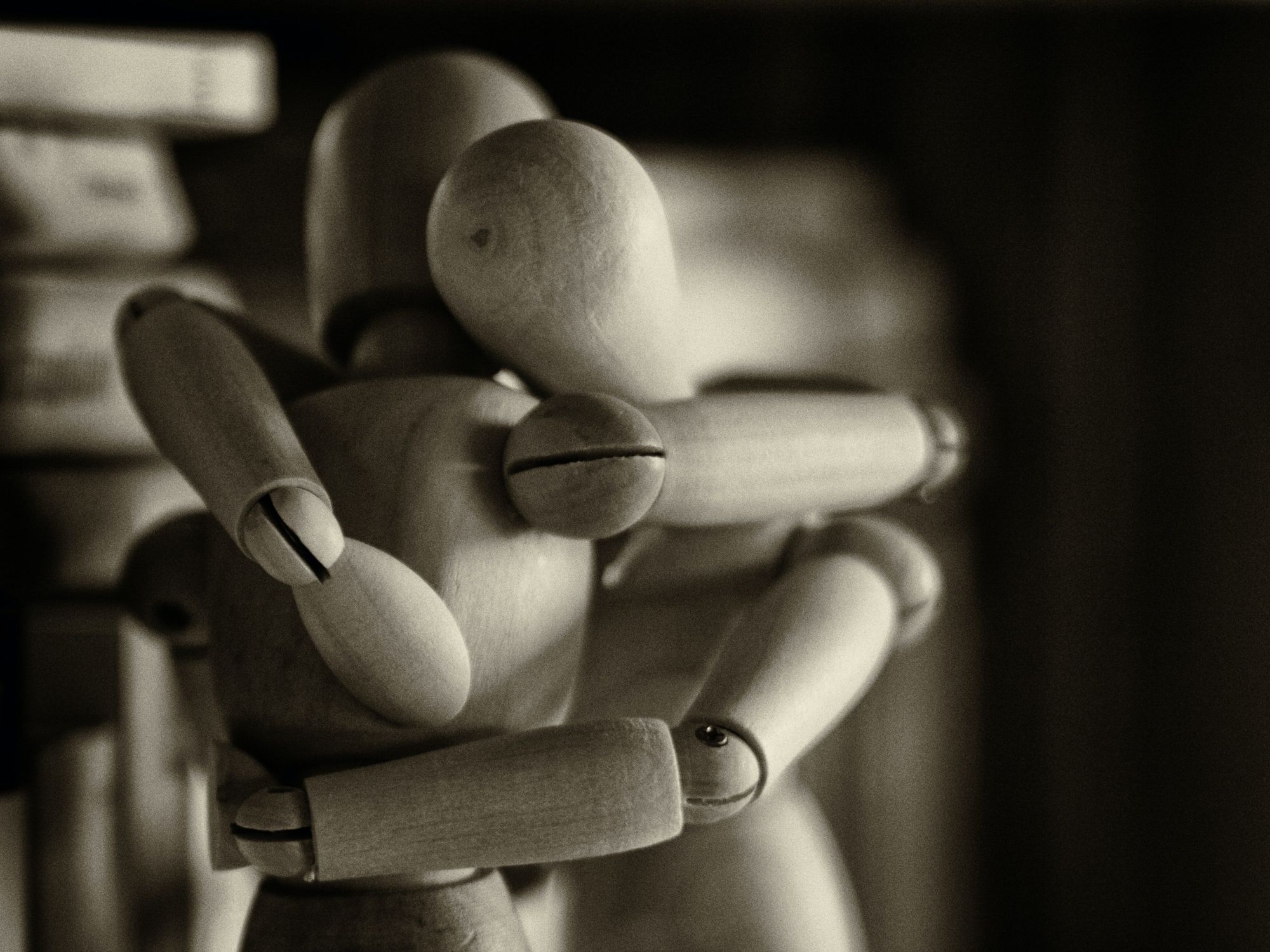 Photo of two wooden mannequins in an embrace