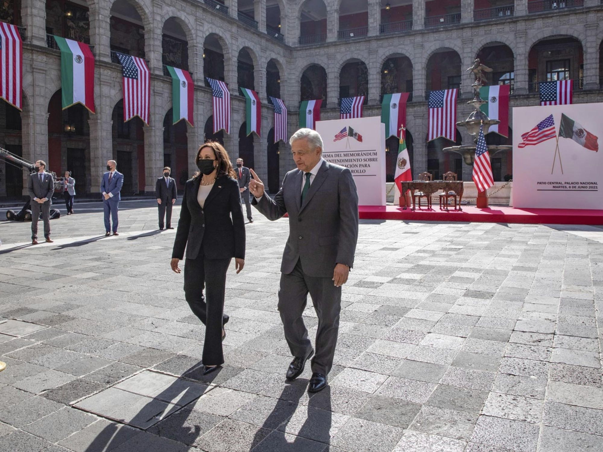 Photo of U.S. ​Vice President Kamala Harris and Mexican President AMLO walking in the couryyard of the National Palace during in Mexico City on June 8
