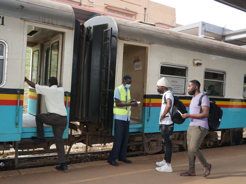 Photo of Uganda Railways Corporation worker Samuel Nyero checks tickets before passengers board the train at Kampala Railway Station.