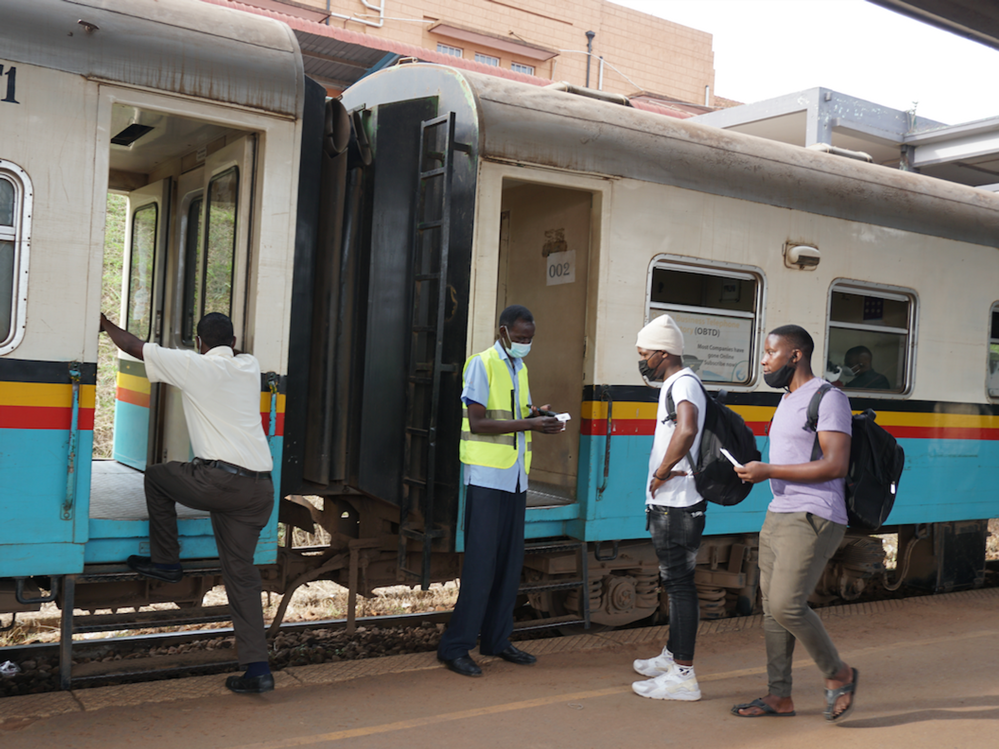 Photo of Uganda Railways Corporation worker Samuel Nyero checks tickets before passengers board the train at Kampala Railway Station.
