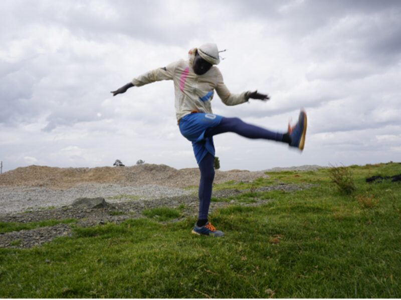 Photo of Ugandan athlete Agong Micheal streatching for his lunchtime run