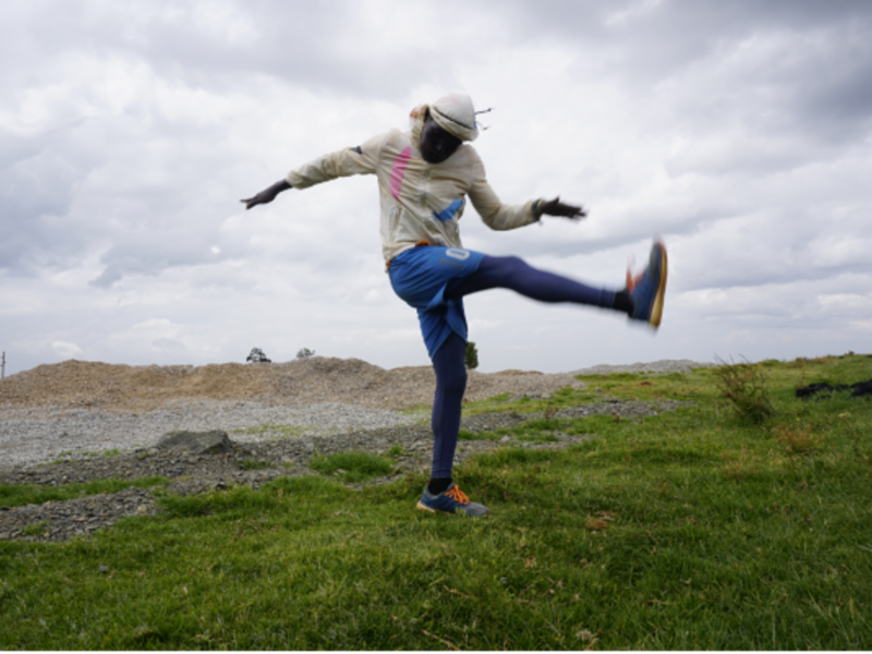 Photo of Ugandan athlete Agong Micheal streatching for his lunchtime run