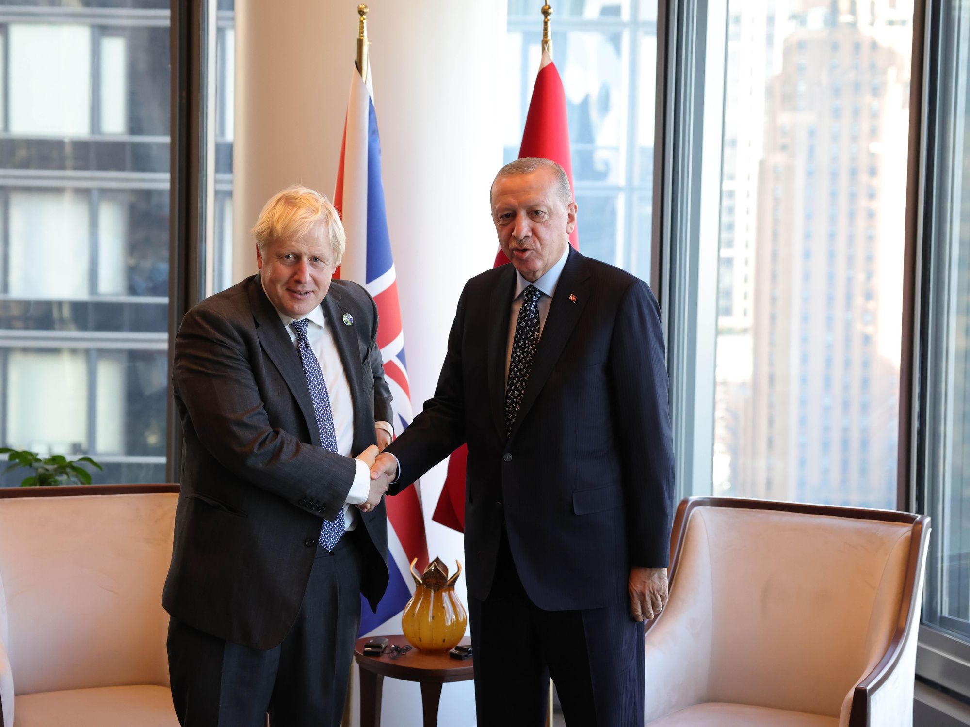 Photo of UK Prime Minister Boris Johnson and Turkish President Recep Tayyip Erdogan shaking hands as they meet in New York on September 20, 2021