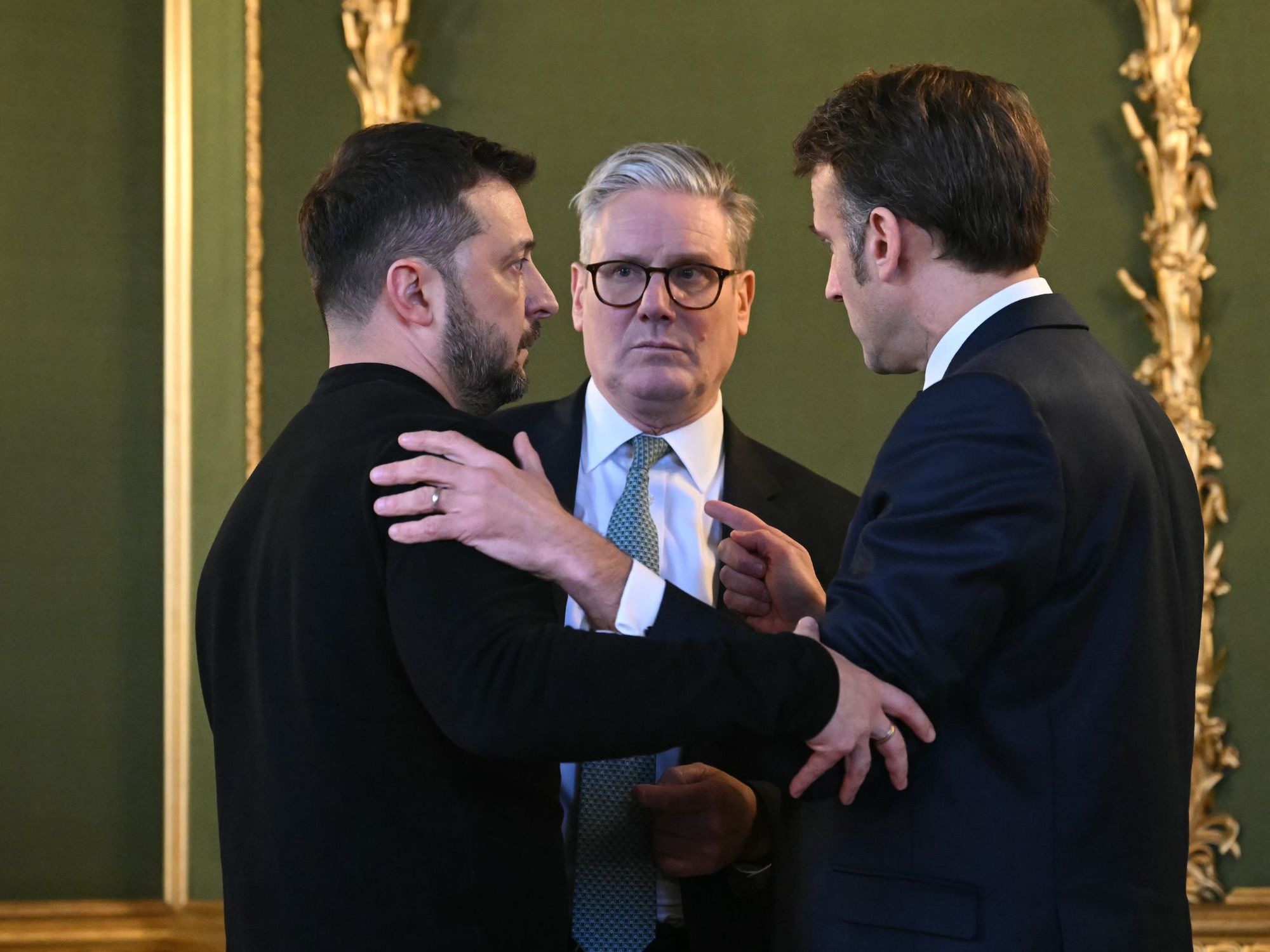 Photo of Ukraine's President Volodymyr Zelensky, Britain's Prime Minister Keir Starmer and France's President Emmanuel Macron embracinf after meeting in London on March 2