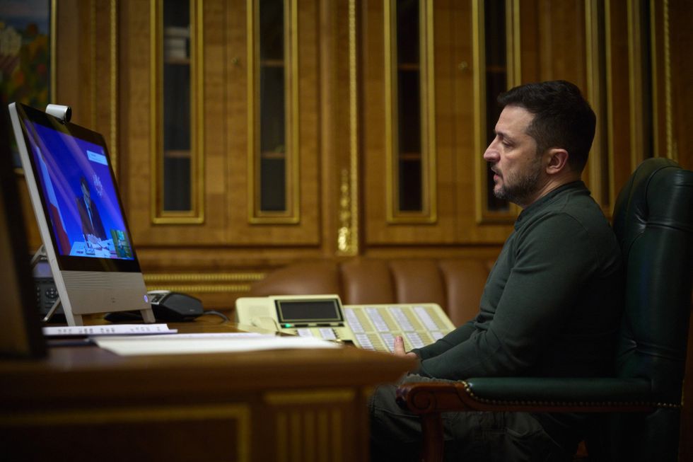 Photo of Ukrainian President Volodymyr Zelenskyy listening to French President Emmanuel Macron during a video conference on February 20 in Kiev, Ukraine.