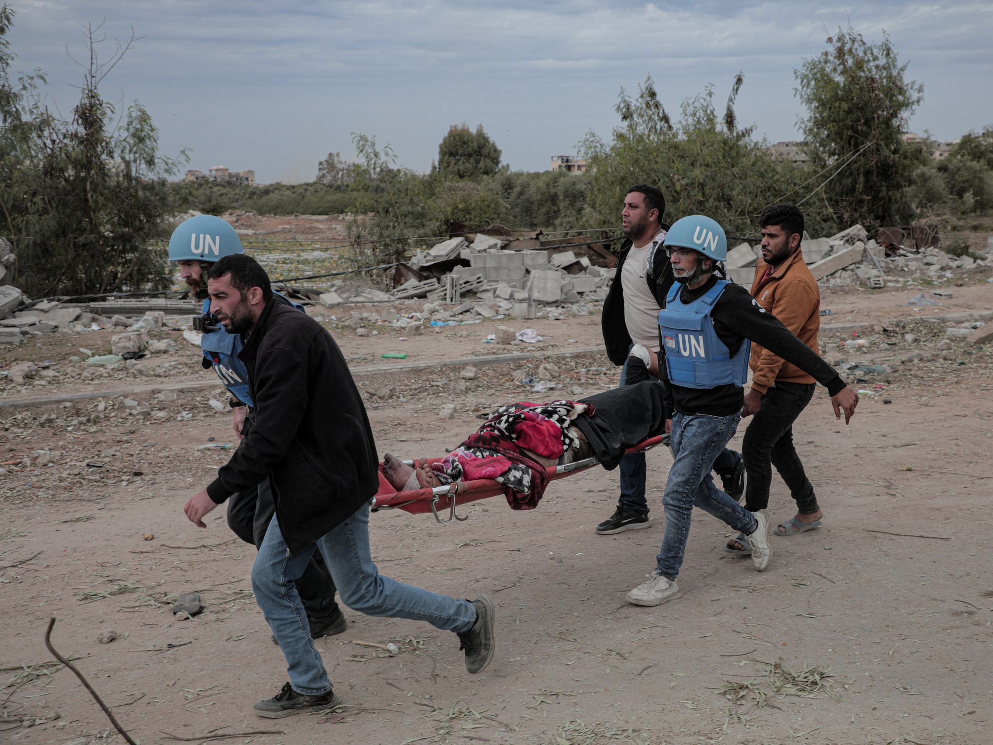 Photo of UN workers carrying an injured Palestinian on a stretcher in northern Gaza on Nov. 25