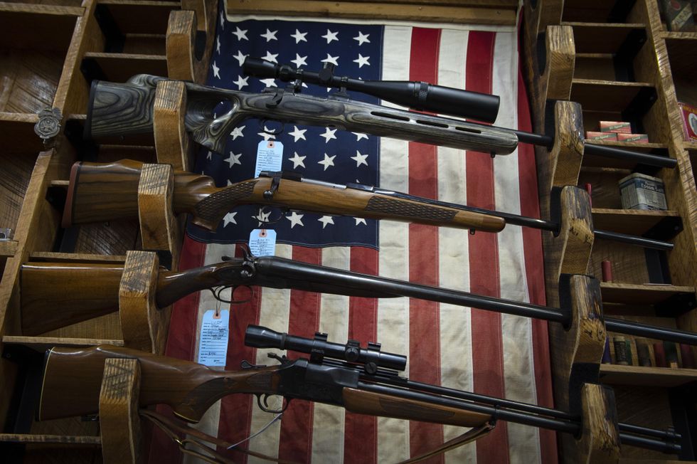 Photo of used rifles for sale in Jasper, U.S., with a U.S. flag in the background