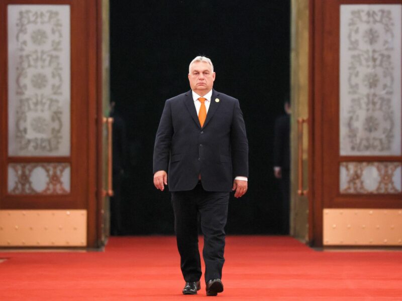 photo of viktor orban walking into a room
