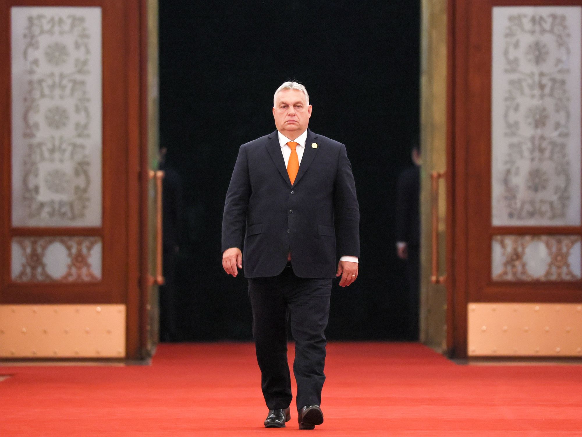 photo of viktor orban walking into a room