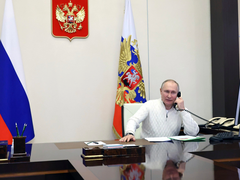 Photo of Vladimir ​Putin sitting at a desk while on the phone, in Moscow on Jan. 5
