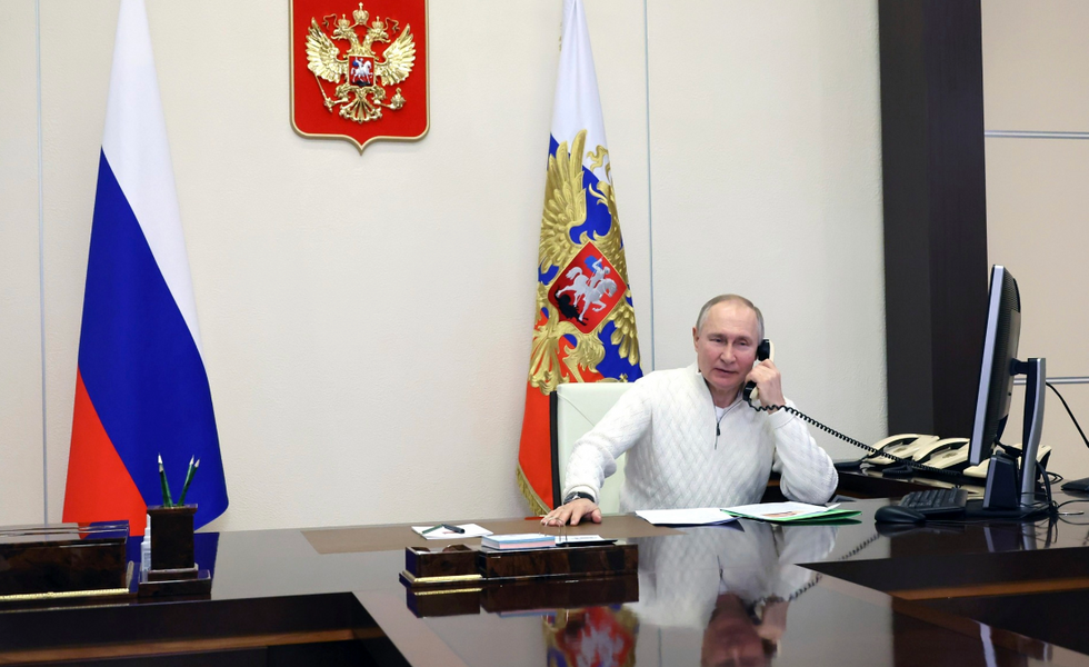 Photo of Vladimir ​Putin sitting at a desk while on the phone, in Moscow on Jan. 5