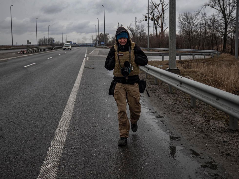 Photo of war photojournalist Maks Levin walking toward the camera