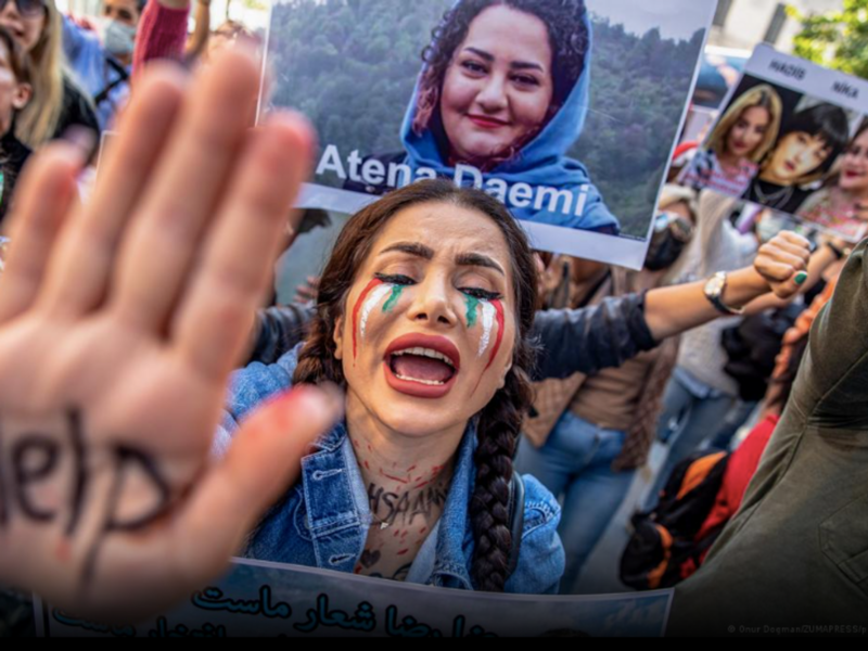 photo of woman holding up hand that says 'help'