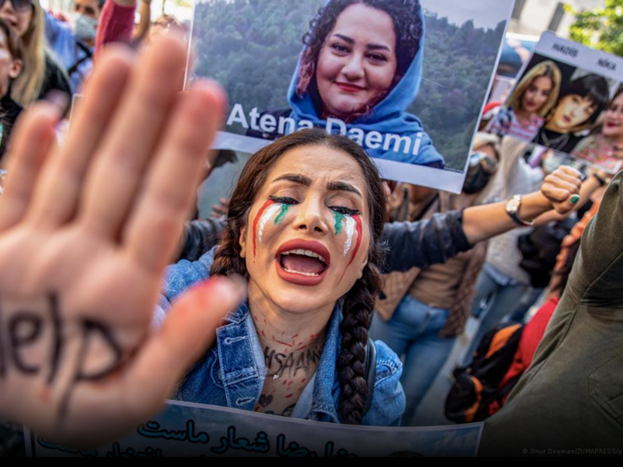 photo of woman holding up hand that says 'help'