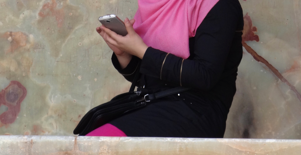 Photo of woman with phone in her hand in Iran