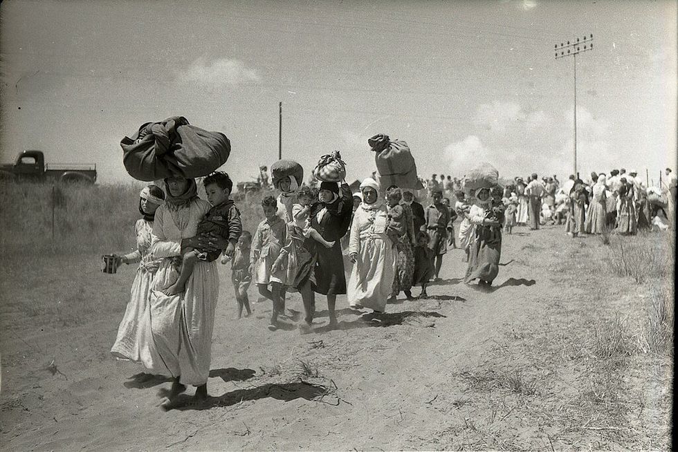 photo of women and children being expelled from their village