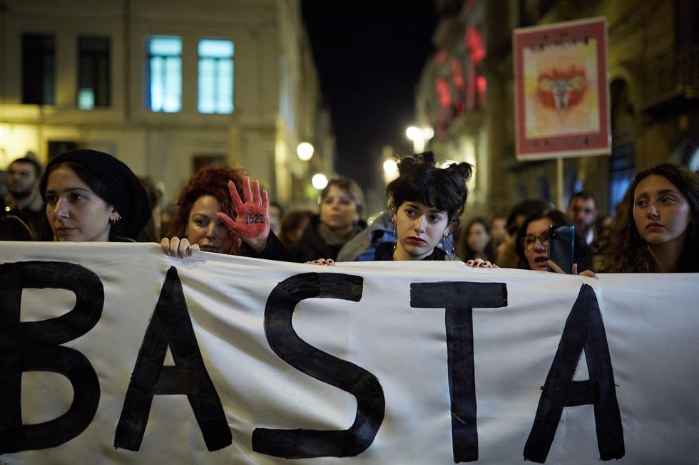 Photo of women at a feminist protest in Italy with the word "Basta" (Stop in Italian)