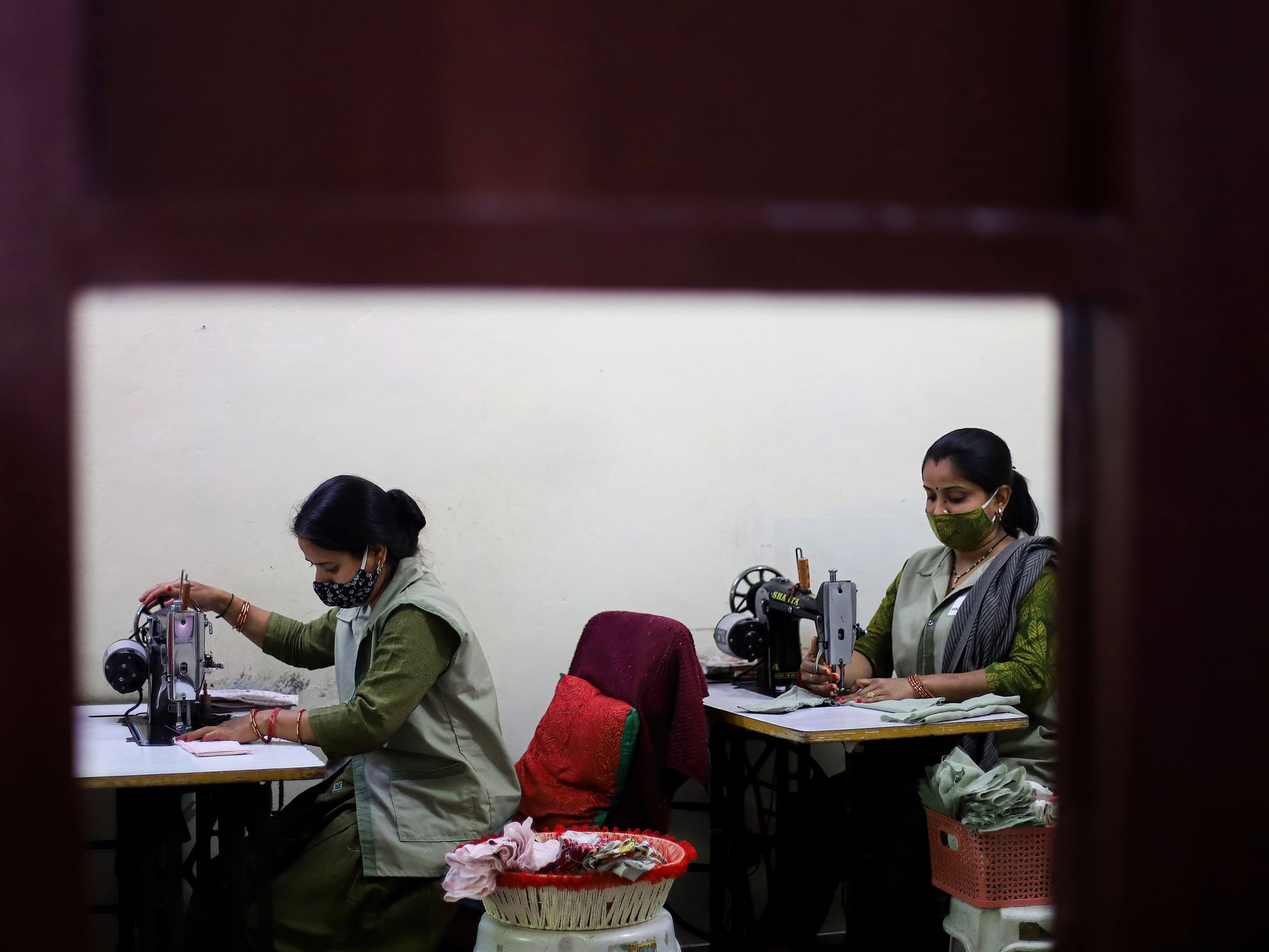 Photo of women in India making cotton cloth reusable sanitary pads
