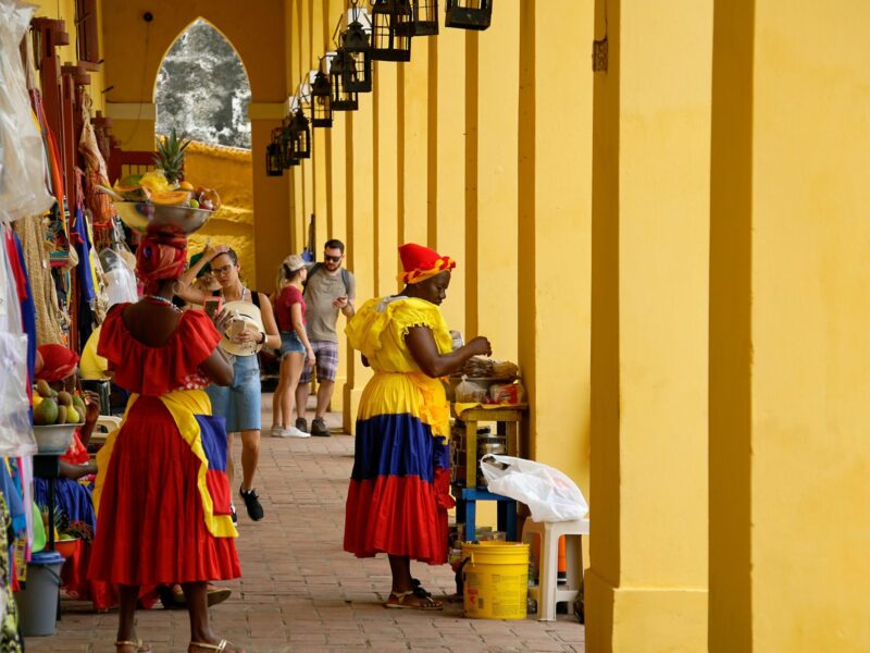 Photo of women in traditional clothes at a market in Cartagena, Colombia