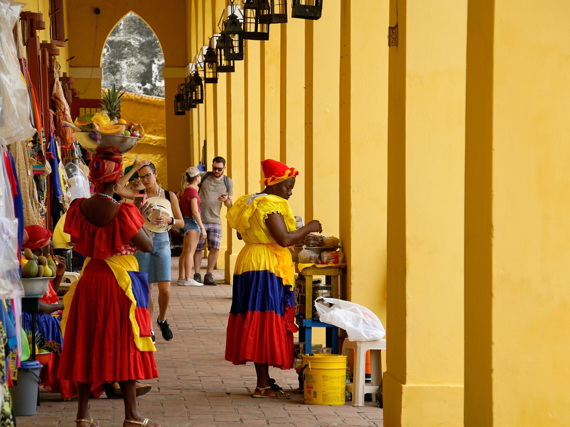 Photo of women in traditional clothes at a market in Cartagena, Colombia