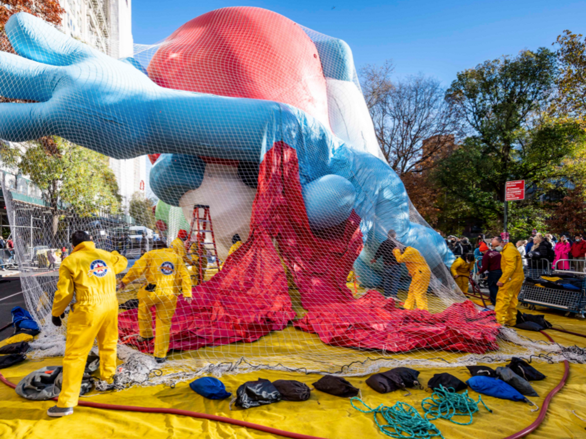 Photo of workers inflating a giant balloon in New York ahead of the 95th Macy's Thanksgiving Parade
