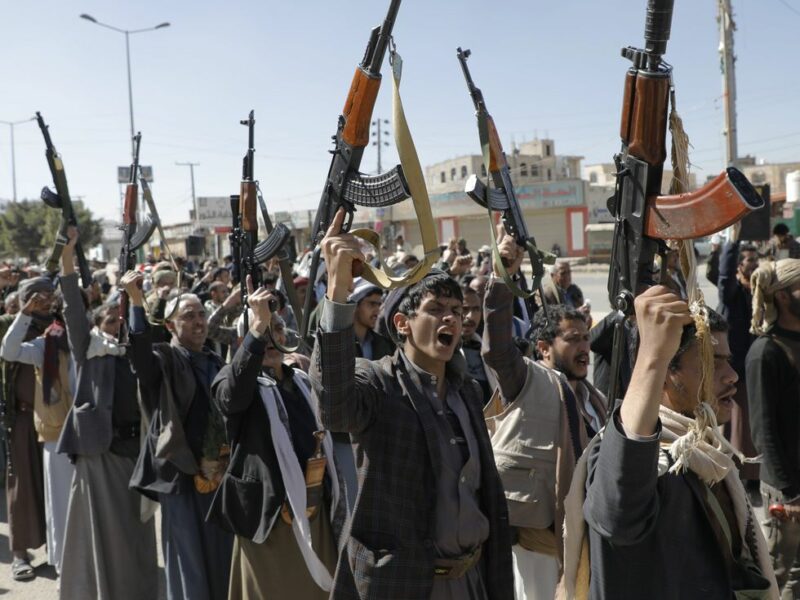 Photo of young Houthi fighters brandishing rifles and chanting as part of a training ceremony in Sanaa, Yemen.