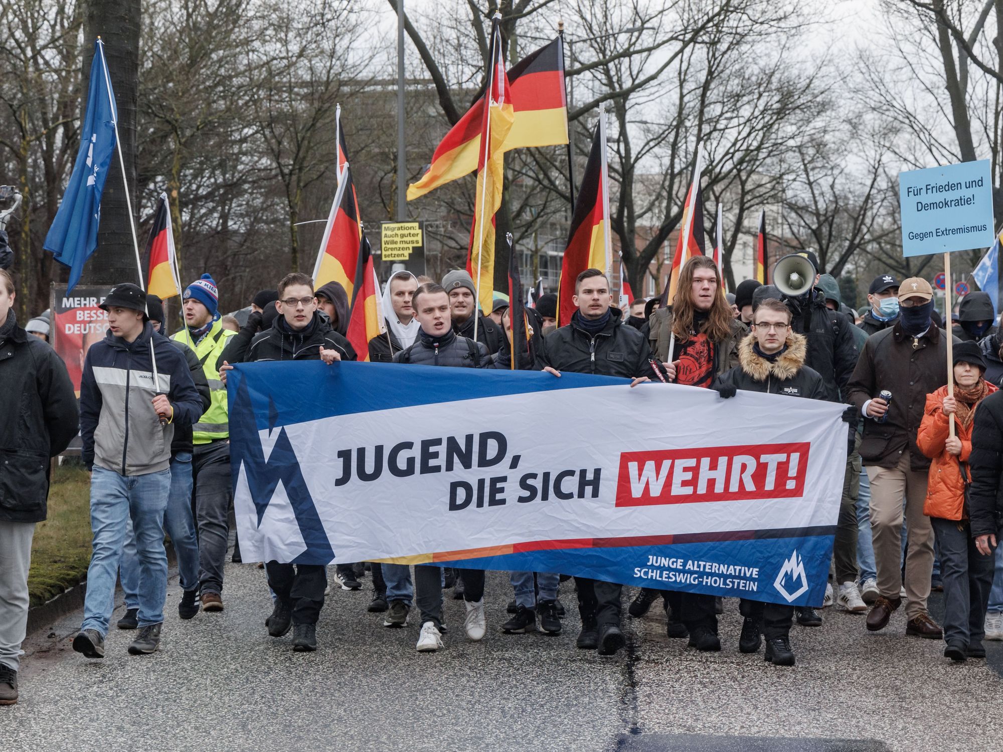 photo of young people carrying a banner