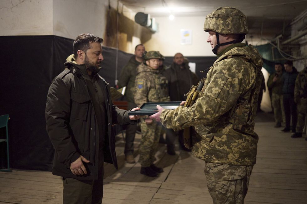 photo of Zelensky handing something to a soldier