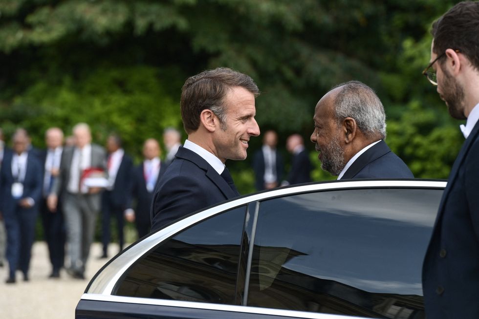 Photo ofFrench President Emmanuel Macron welcoming the President of the Republic of Djibouti Ismail Omar Guelleh in Paris on July 24.