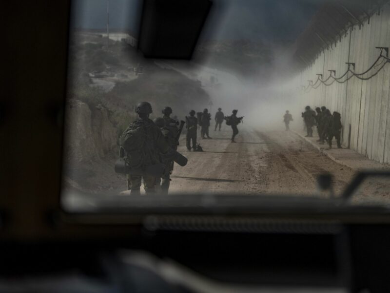 Photo taken from the inside of a car of IDF soldiers walking in the southern Lebanese village of Naqoura along the border with Israel.
