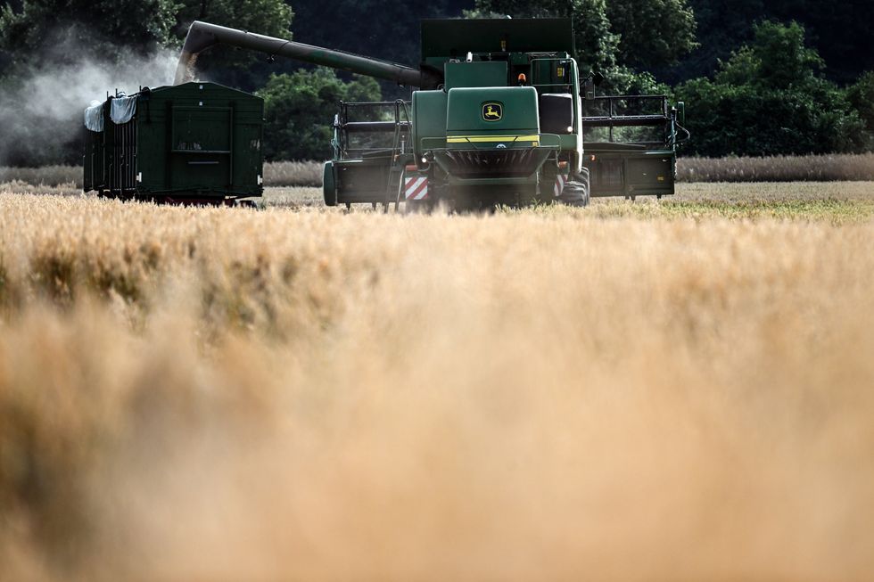 Photograph of a farmer harvesting grain with his combine harvester.​