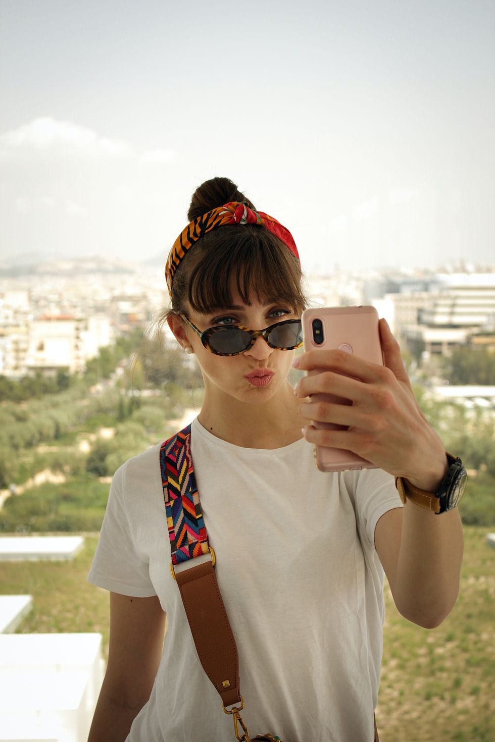 Photograph of a girl pursing her lips as she takes a selfie