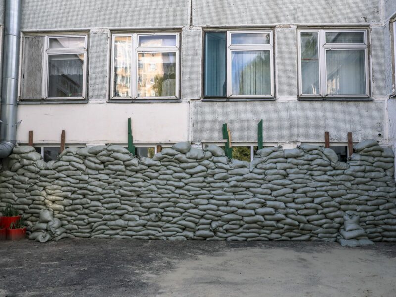 Photograph of a kindergarten in Belgorod, Russia, where sand bags are seen protecting the windows