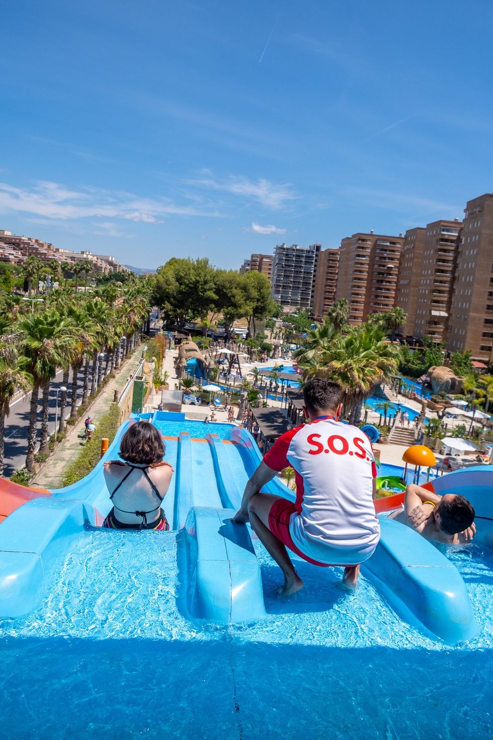 photograph of a lifeguard helping guests go down a waterslide at Marina d'Or