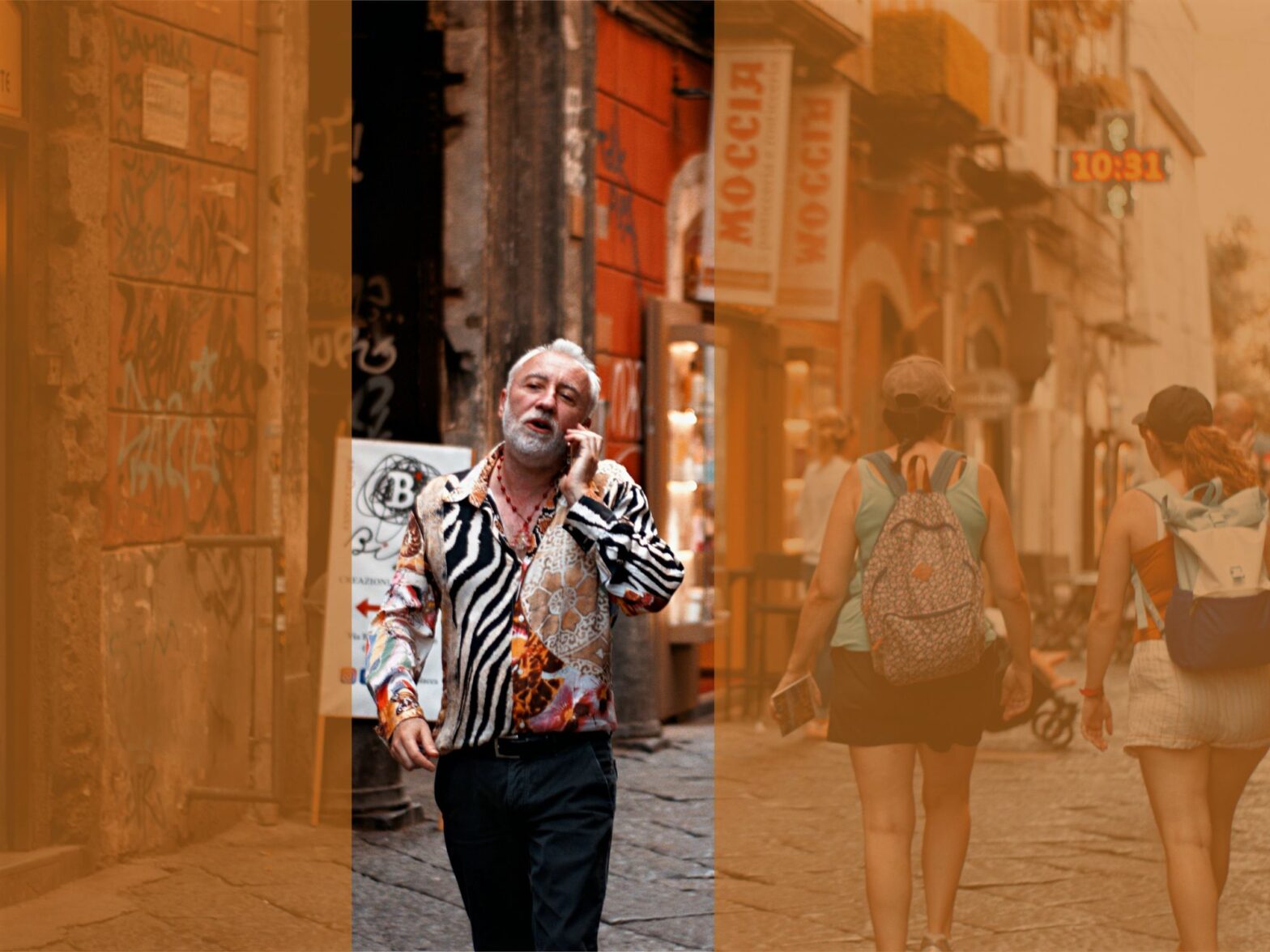 Photograph of a man in a zebra print shirt walking down a Neapolitan street. He is talking on the phone.
