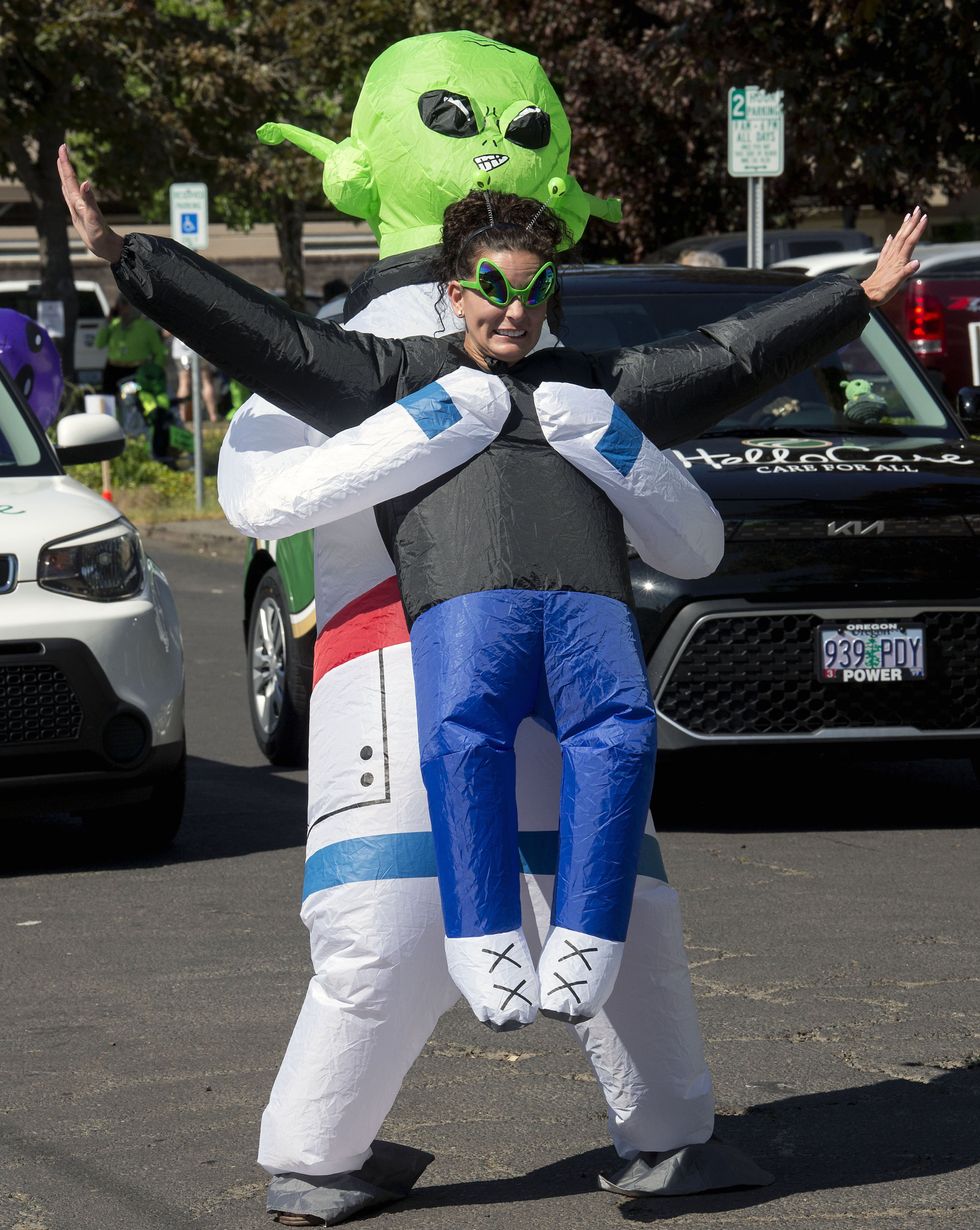 Photograph of a woman dressed up as a human being kidnapped by an alien at the 23rd Annual McMenamins UFO Festival commemorates the sighting of a UFO in 1950 by McMinnville farmer Paul Trent.
