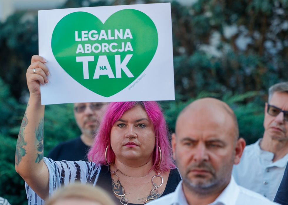 Photograph of a woman in Polish in protest demanding an end to harassment of women by pro-life organizations.
