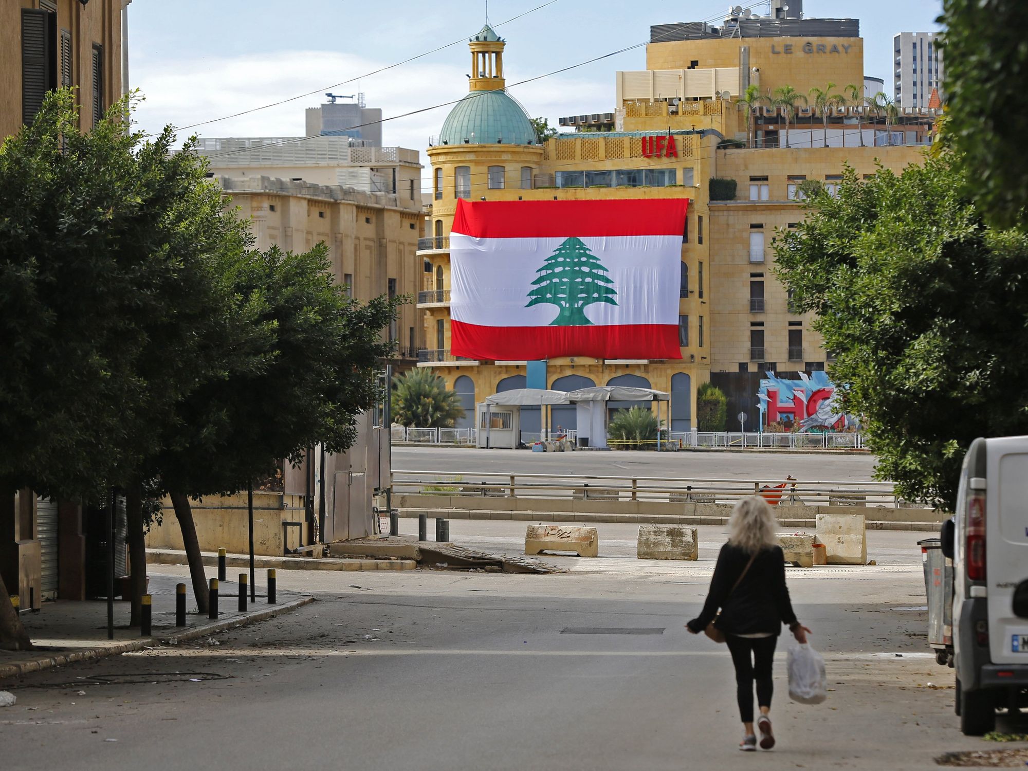 Photograph of a woman walking down the street in Beirut.