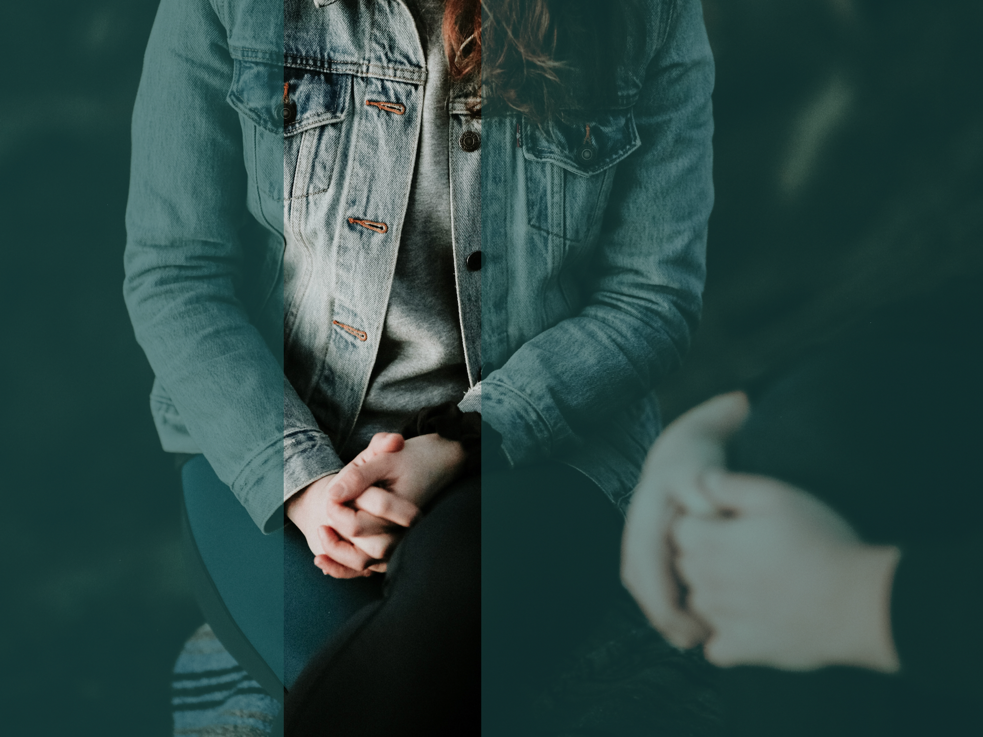 Photograph of a woman's hands clasping one another as she sits.
