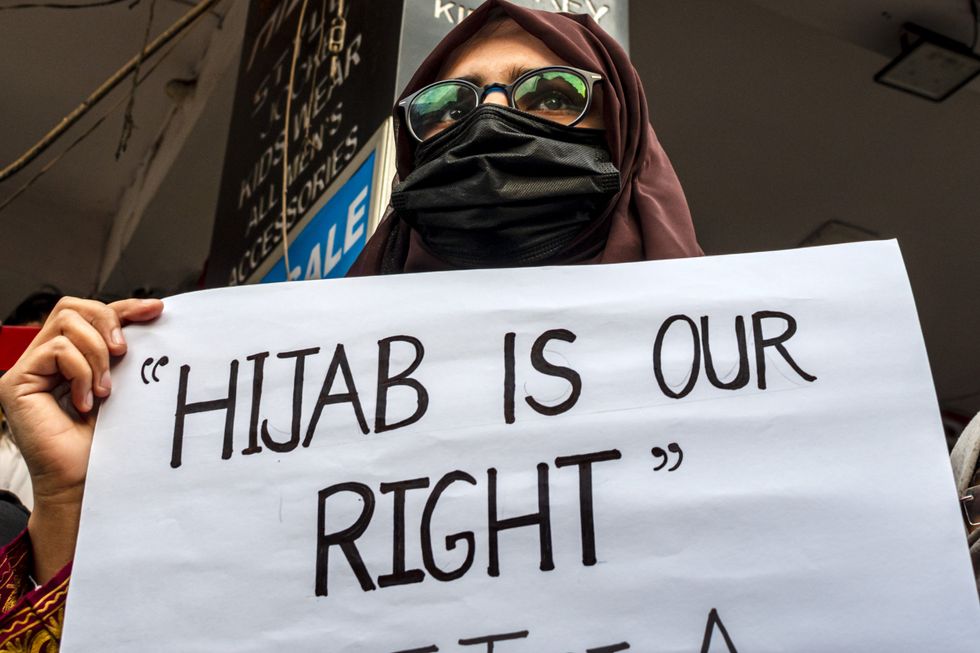 Photograph of an activist holding up a poster that reads "hijab is our right", during a protest against the hijab ban in schools and colleges of Karnataka state.
